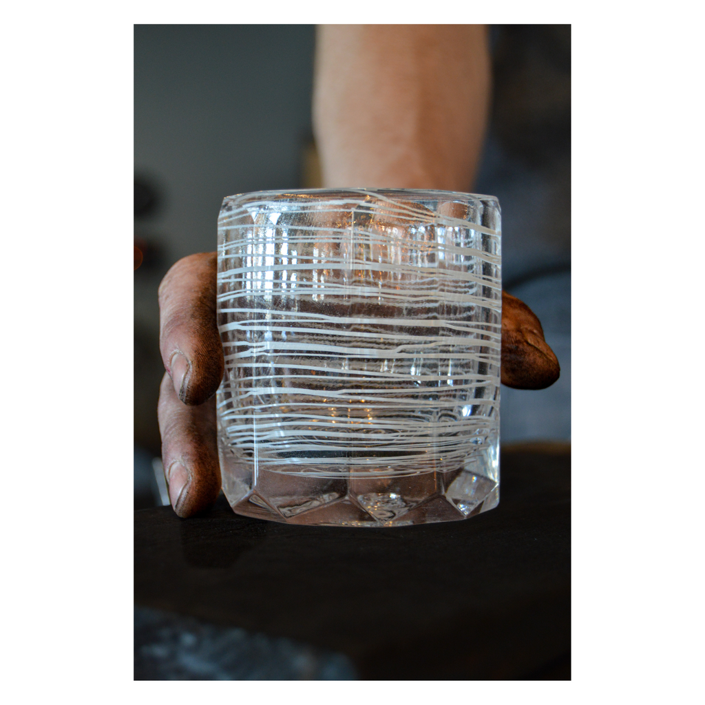 hand holding a blown glass artist cup 