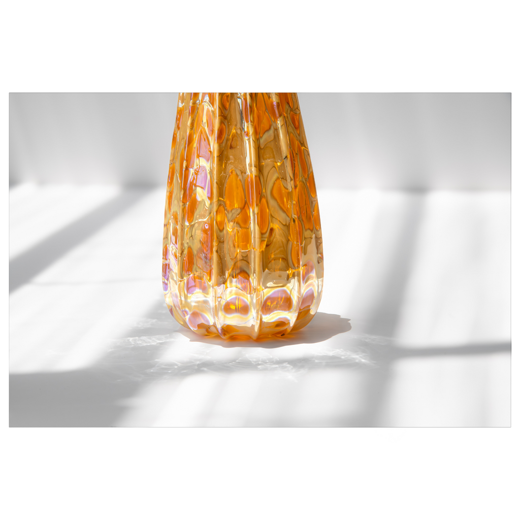 Decorative glass gourd with a textured pattern on a white background