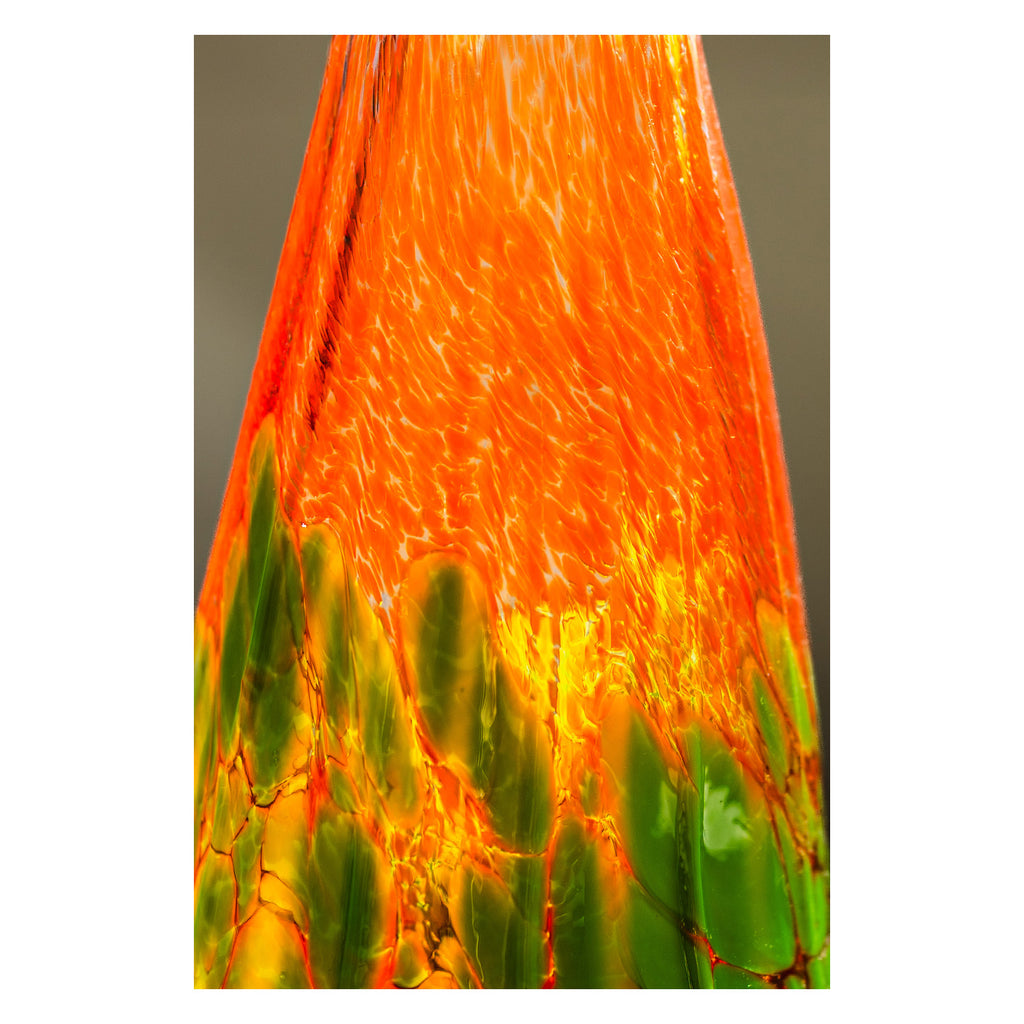 Close-up of spooky pumpkin with orange and green colors.