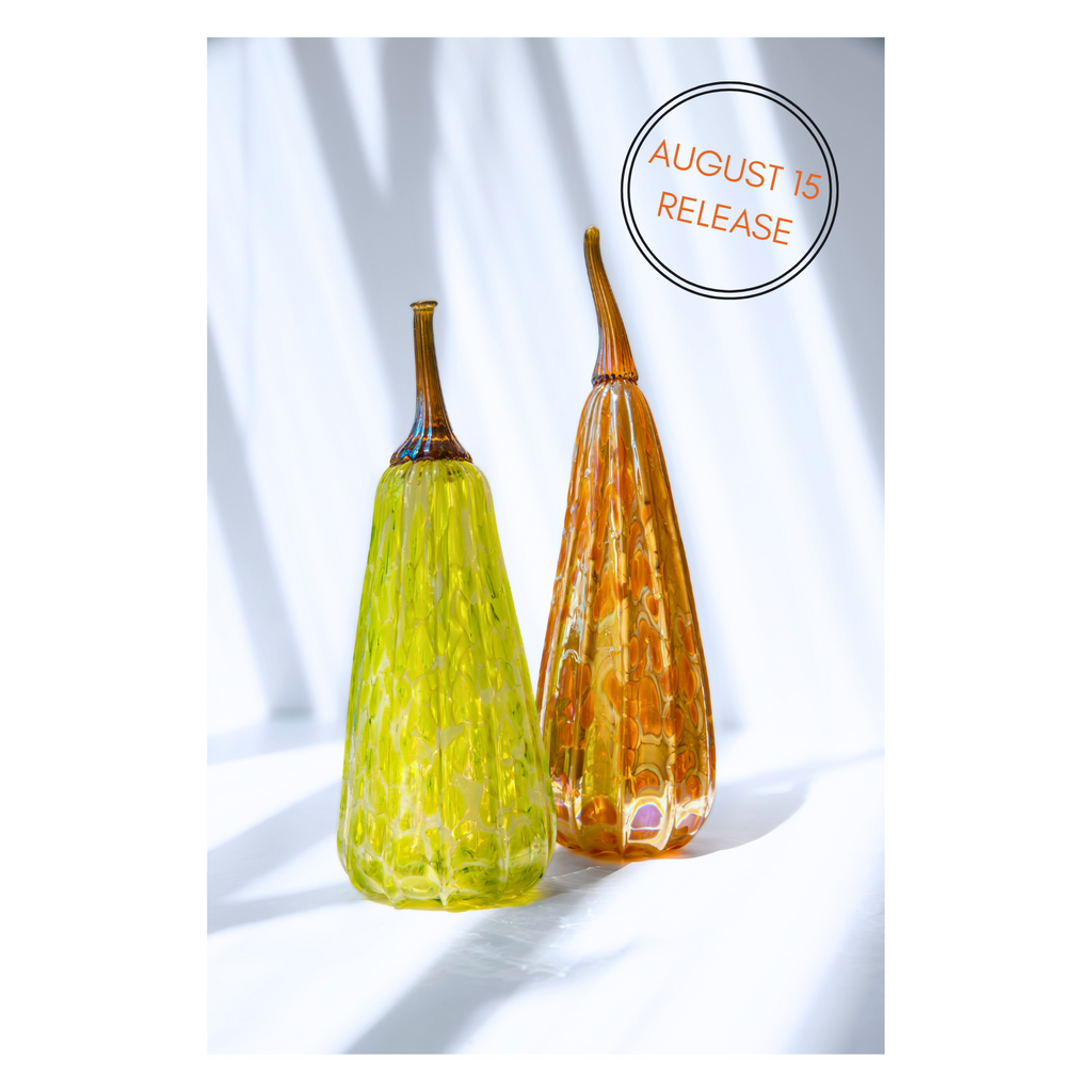 An assortment of handcrafted glass gourds displayed against a clean white background, showcasing their unique shapes and vibrant colors.